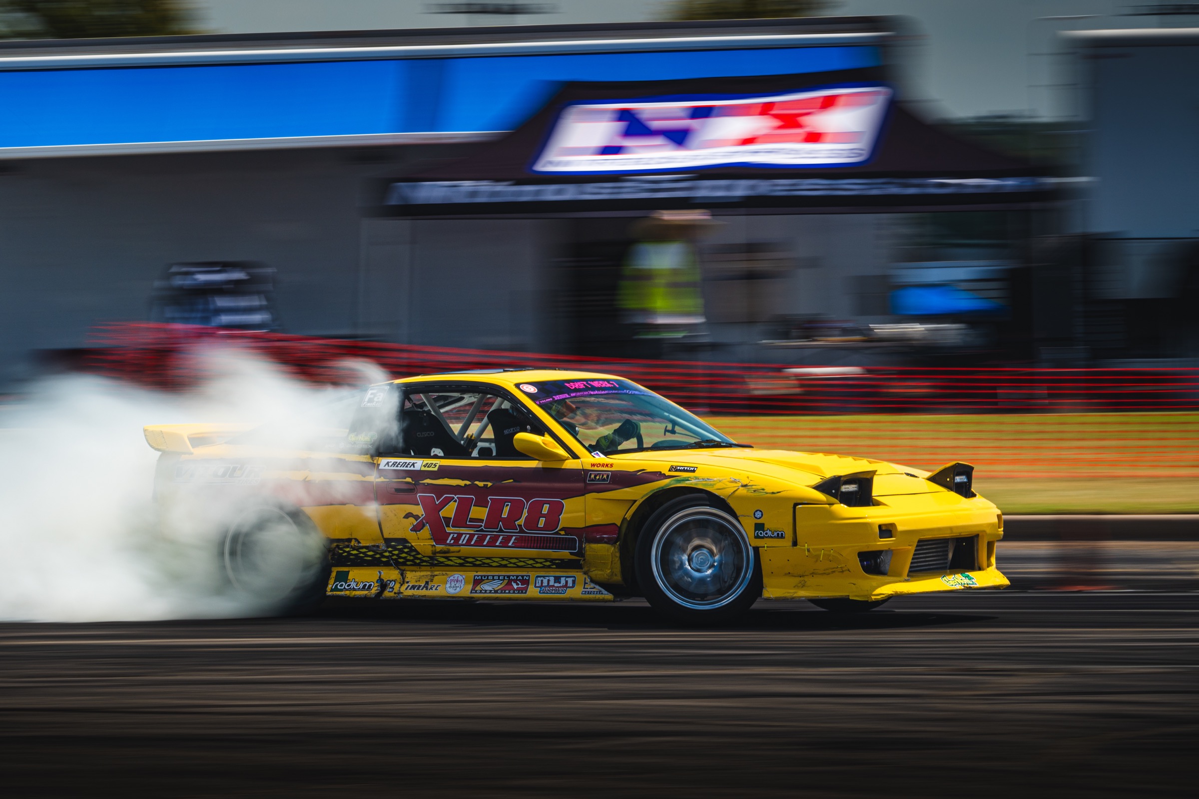 Yellow XLR8 drift car drifting in a side view